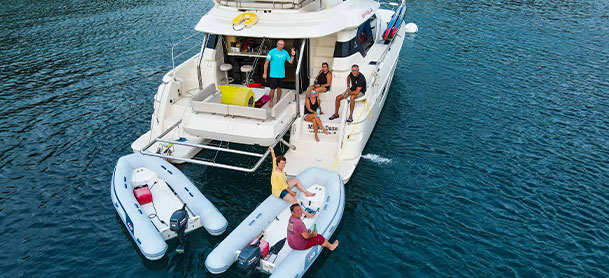 Boat on the water with people on rafts 