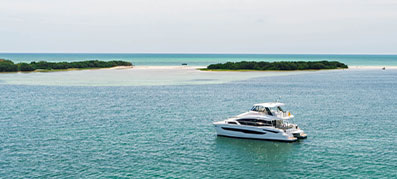 MarineMax 545 in the water with island in the distance