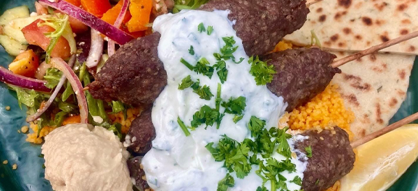 Greek Spread of Lamb Koftas, Haloumi, Roasted Vegetables, Greek Salad, Tzatziki, Humus and fresh pitas 