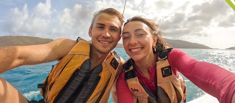 Payton and guest wearing swim vests aboard a vessel in the BVI